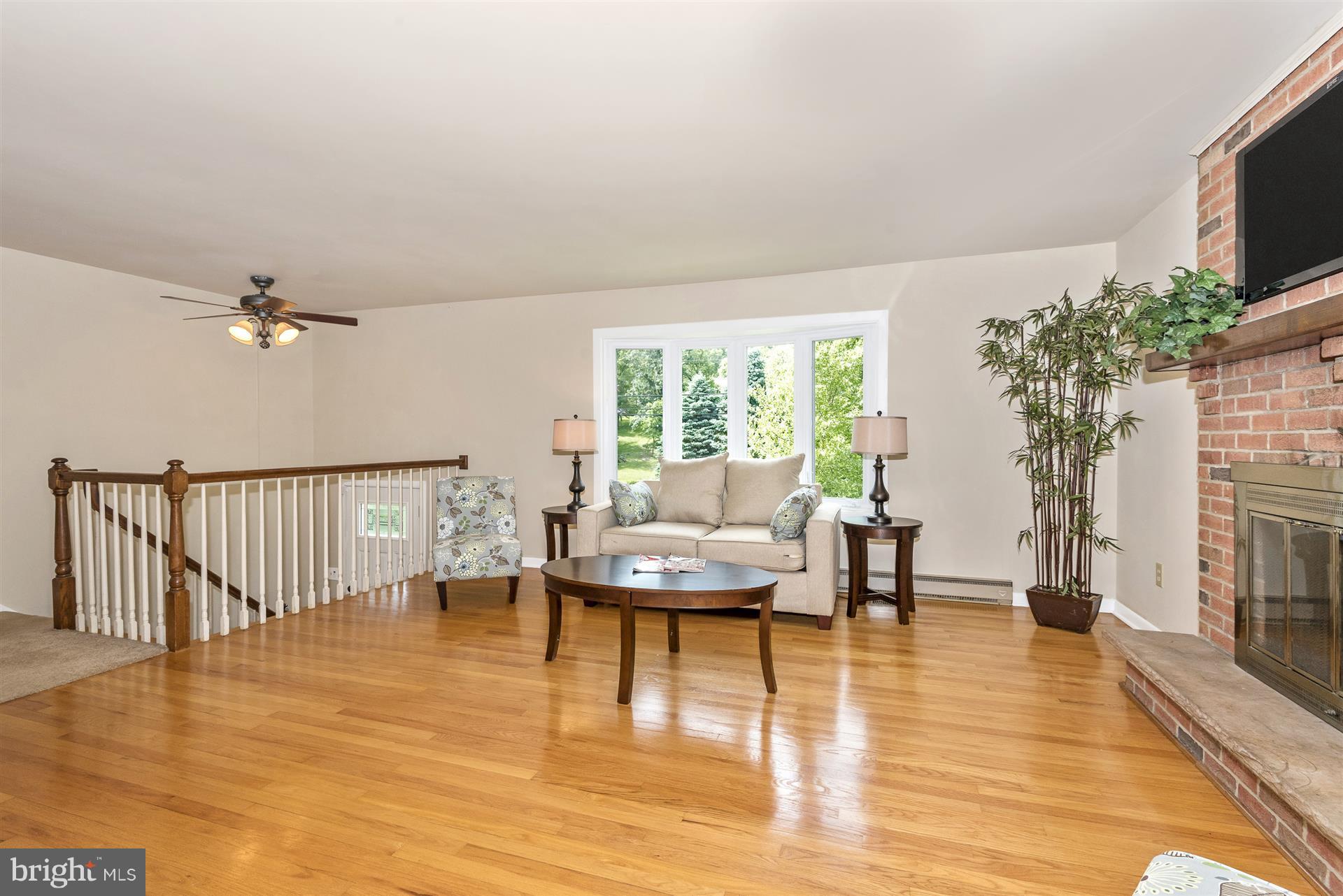 8835 Indian Springs Road Frederick, MD 21702 - Photo 5 of 30 Hardwood flooring in the living room and bay windo