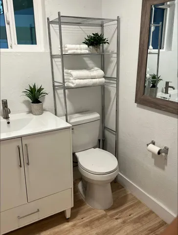 a bathroom with a sink a toilet and mirror