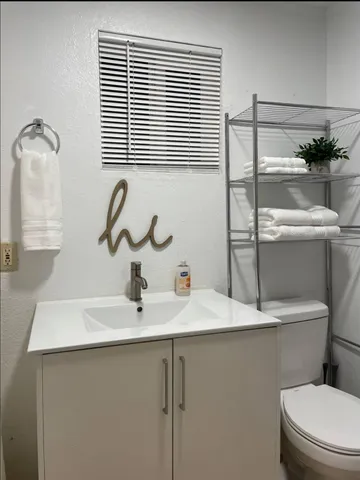 a bedroom with a bed and painting on the wall