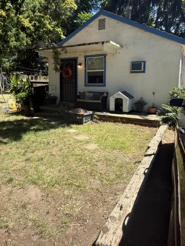 a view of a house with a yard covered in snow