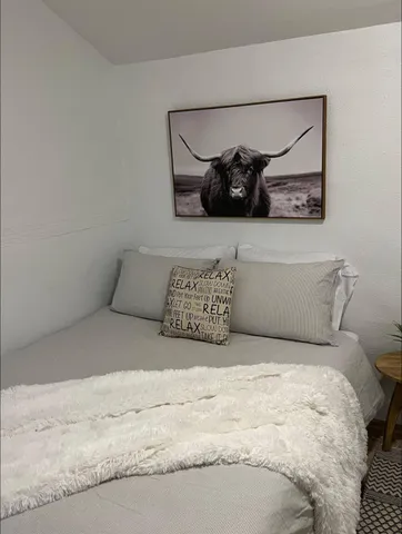 a bedroom with a large bed and a couch