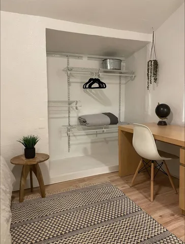 a bedroom with a bed and a painting on the wall