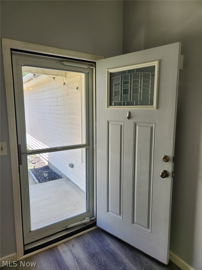 5203 Cline Road Kent, OH 44240 - Photo 23 of 33 Entryway featuring a decorative paneled door with an integrated stained glass window, complemented by a full-lite storm door
