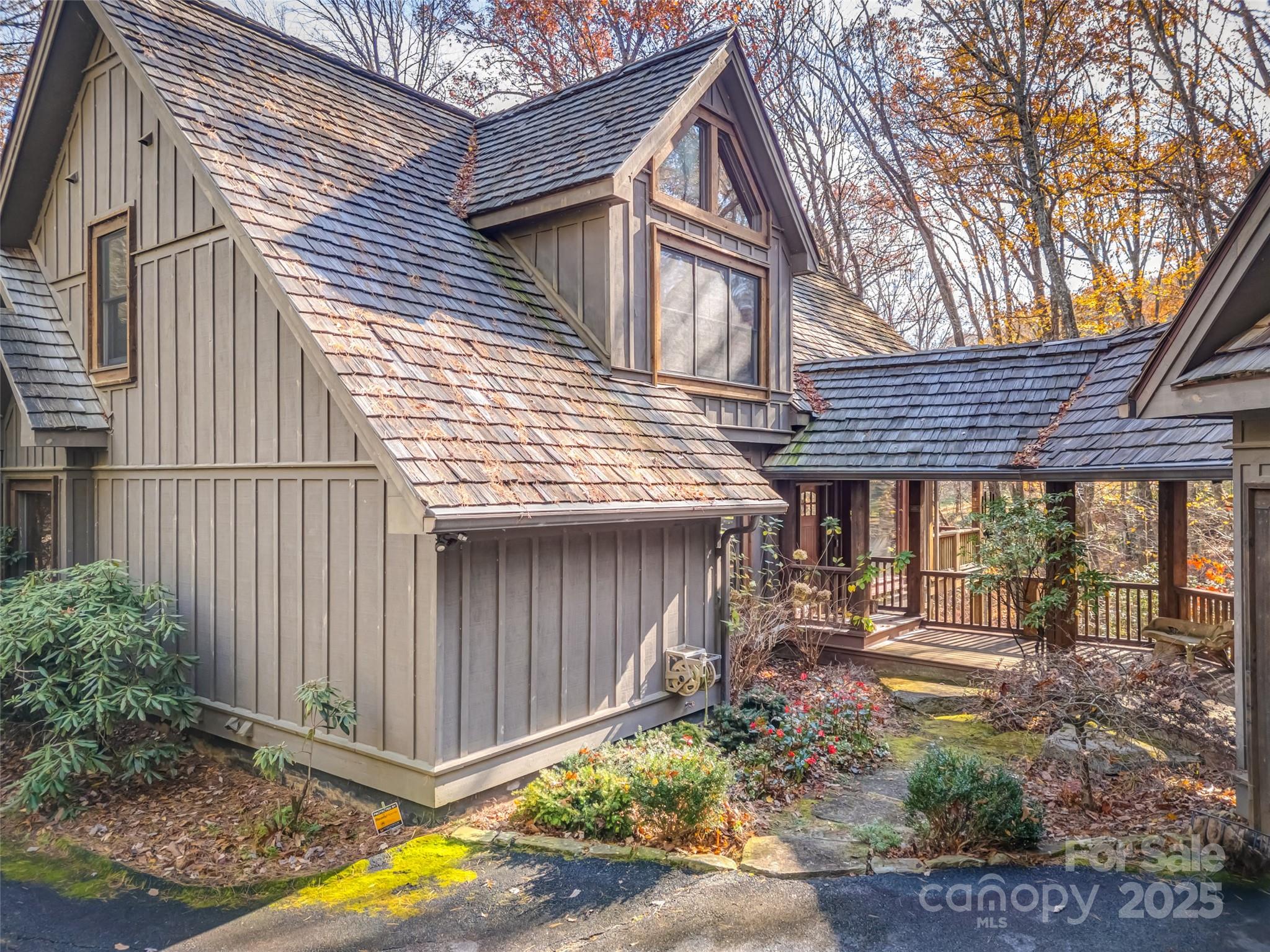 a view of a house with a small yard and wooden fence