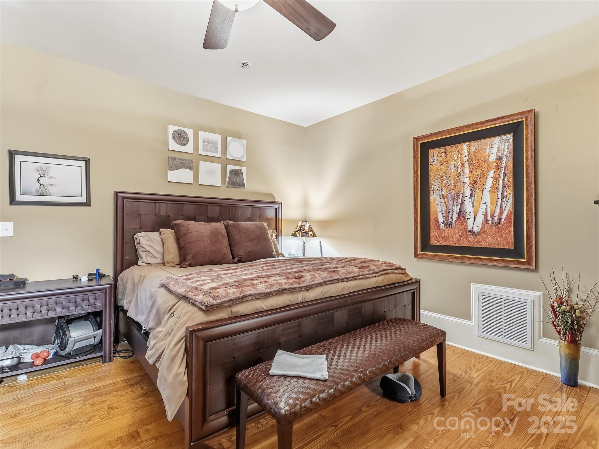 129 Ivy Ridge, Unit I26 Lake Toxaway, NC 28747 - Photo 14 of 39 a bedroom with a bed and wooden floor