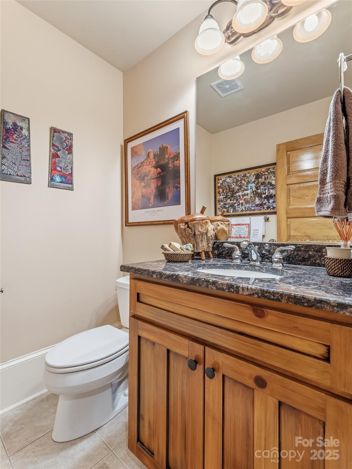 129 Ivy Ridge, Unit I26 Lake Toxaway, NC 28747 - Photo 18 of 39 a bathroom with a granite countertop toilet sink and mirror
