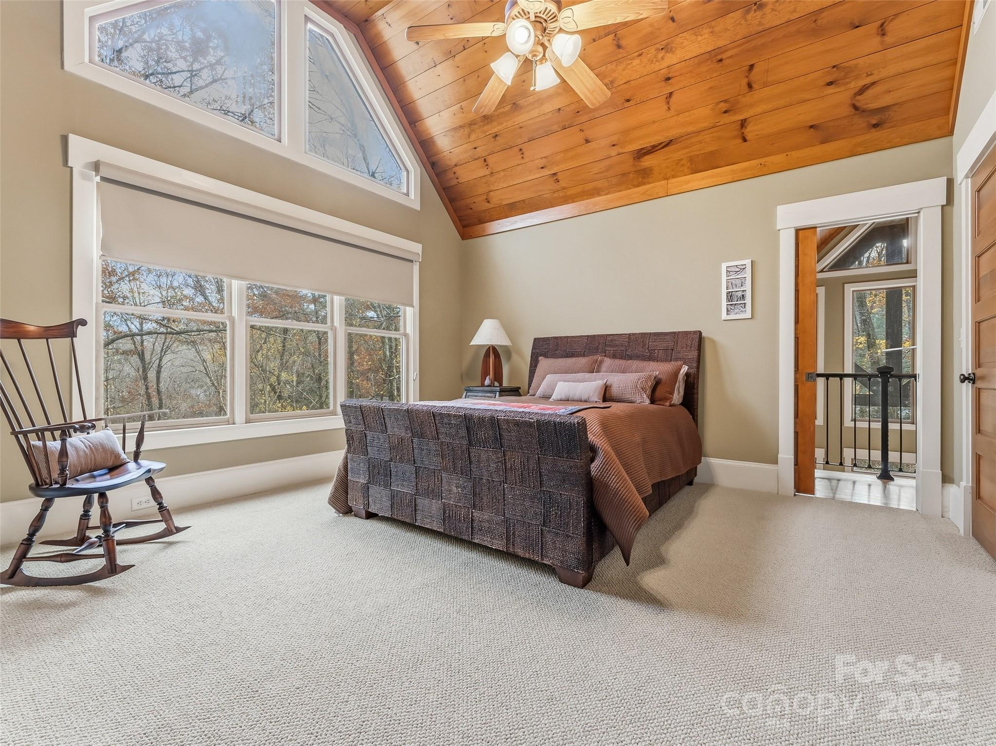 129 Ivy Ridge, Unit I26 Lake Toxaway, NC 28747 - Photo 19 of 39 a bedroom with furniture and large windows