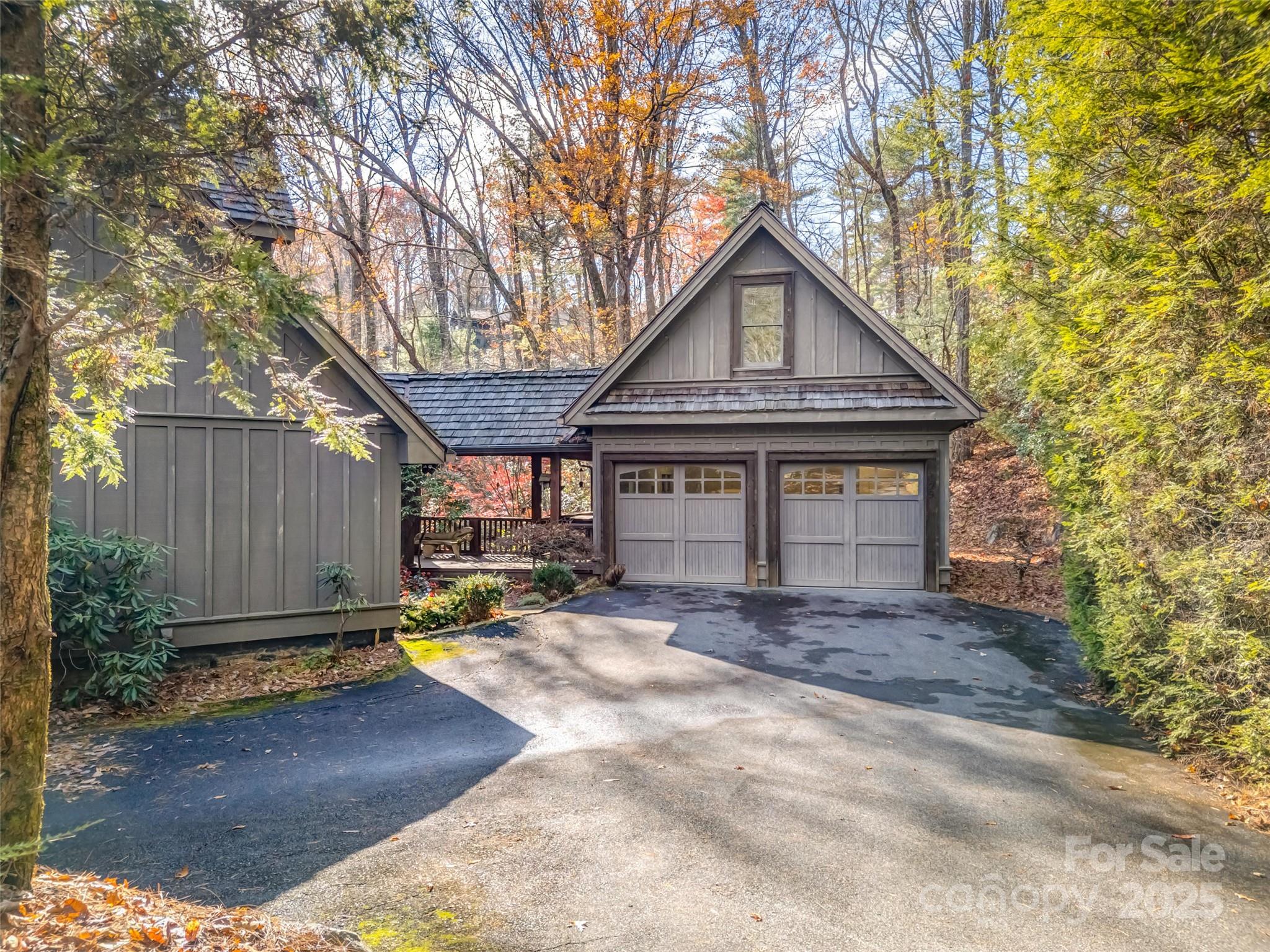 129 Ivy Ridge, Unit I26 Lake Toxaway, NC 28747 - Photo 2 of 39 a front view of a house with a yard and tree s