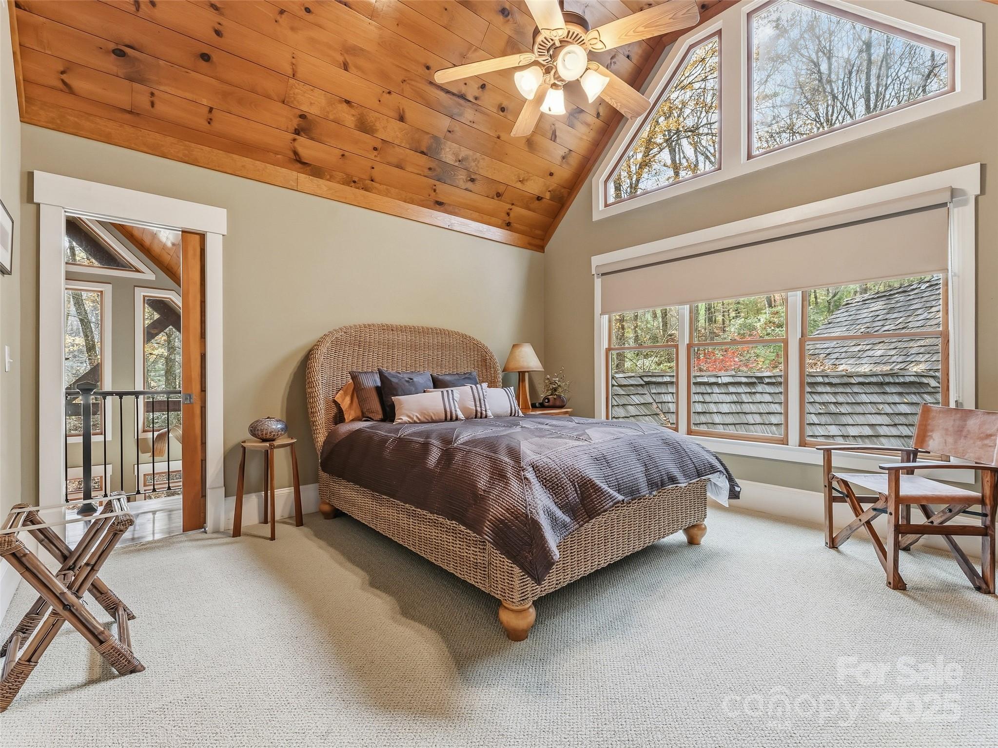 129 Ivy Ridge, Unit I26 Lake Toxaway, NC 28747 - Photo 21 of 39 a spacious bedroom with a bed and large windows