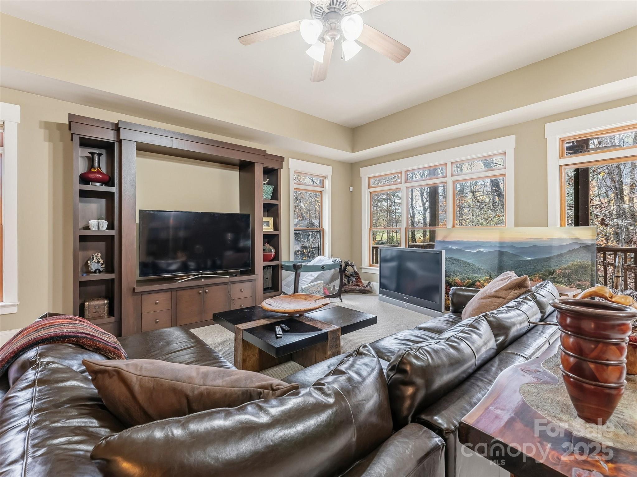 129 Ivy Ridge, Unit I26 Lake Toxaway, NC 28747 - Photo 27 of 39 a living room with furniture and a flat screen tv