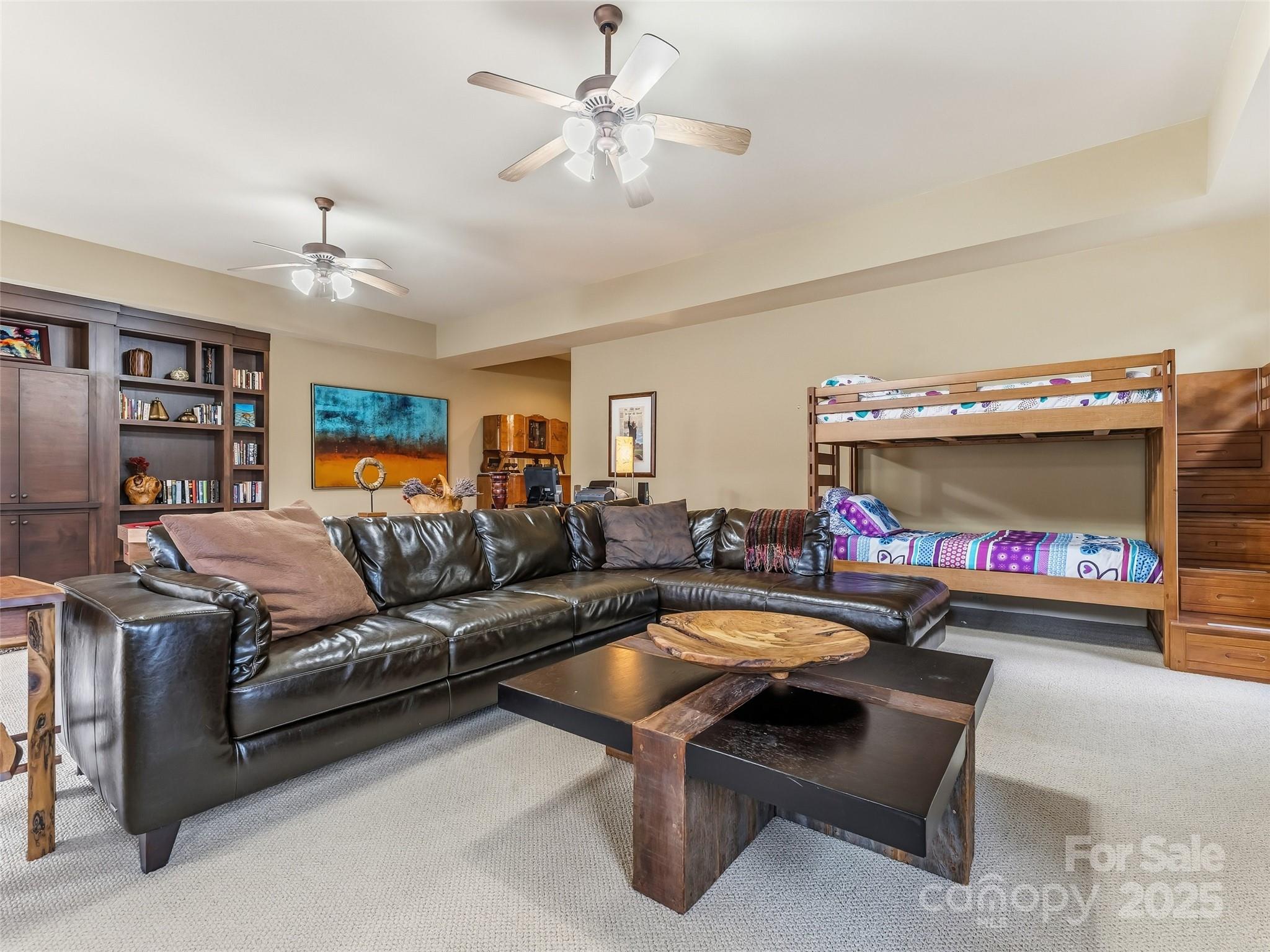 129 Ivy Ridge, Unit I26 Lake Toxaway, NC 28747 - Photo 29 of 39 a living room with furniture a fireplace and a chandelier