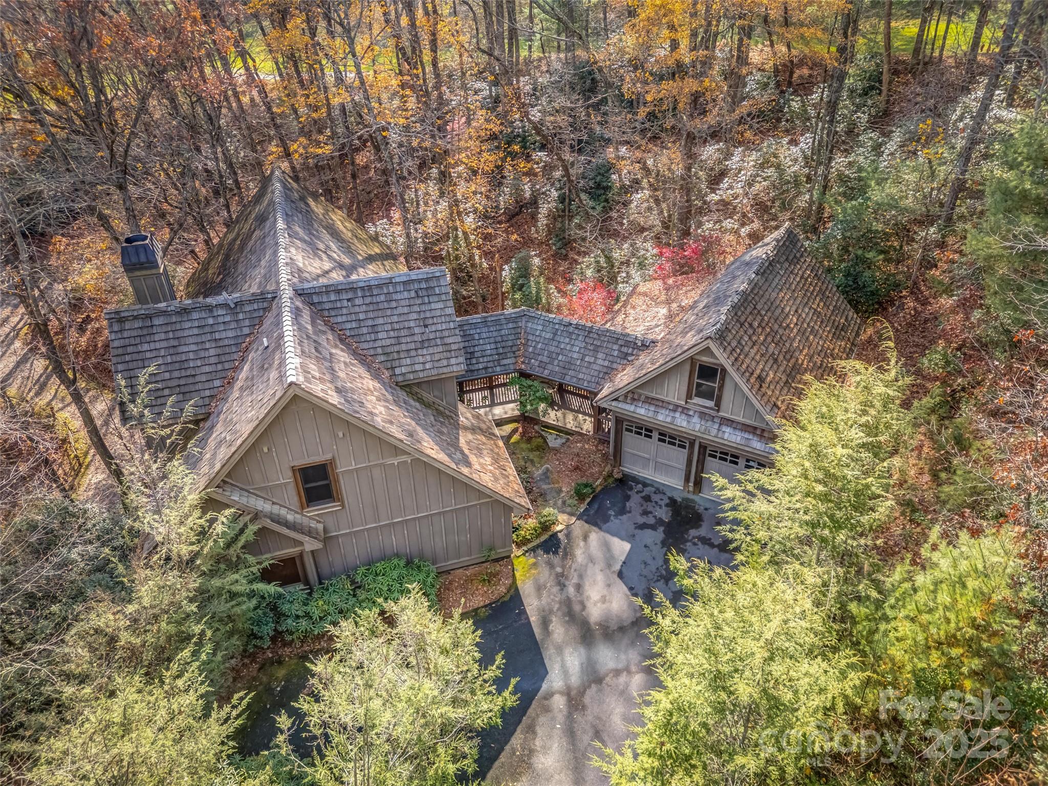 129 Ivy Ridge, Unit I26 Lake Toxaway, NC 28747 - Photo 34 of 39 a aerial view of a house with a yard and potted plants