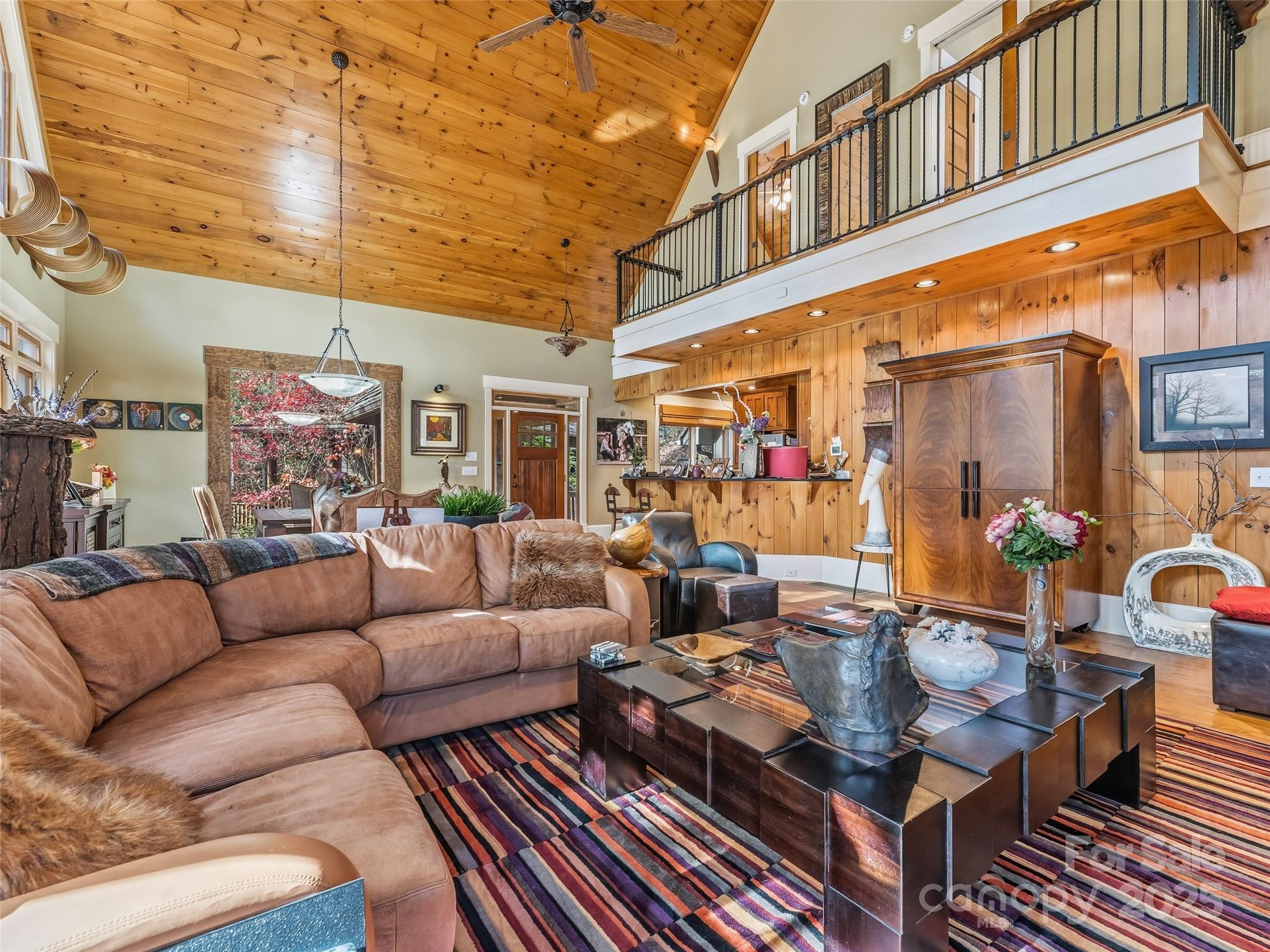 129 Ivy Ridge, Unit I26 Lake Toxaway, NC 28747 - Photo 9 of 39 a living room with furniture a rug and a chandelier