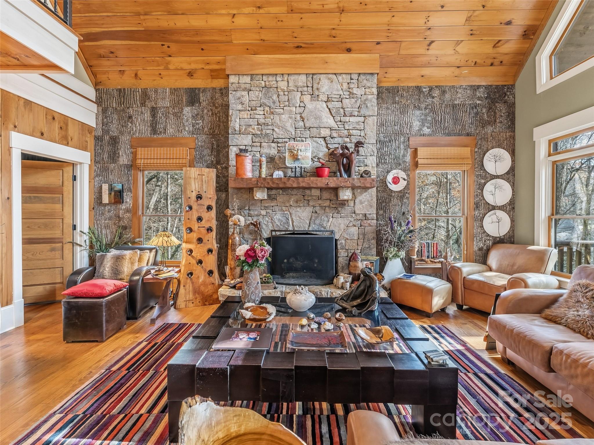 129 Ivy Ridge, Unit I26 Lake Toxaway, NC 28747 - Photo 10 of 39 a living room with patio furniture and a fireplace