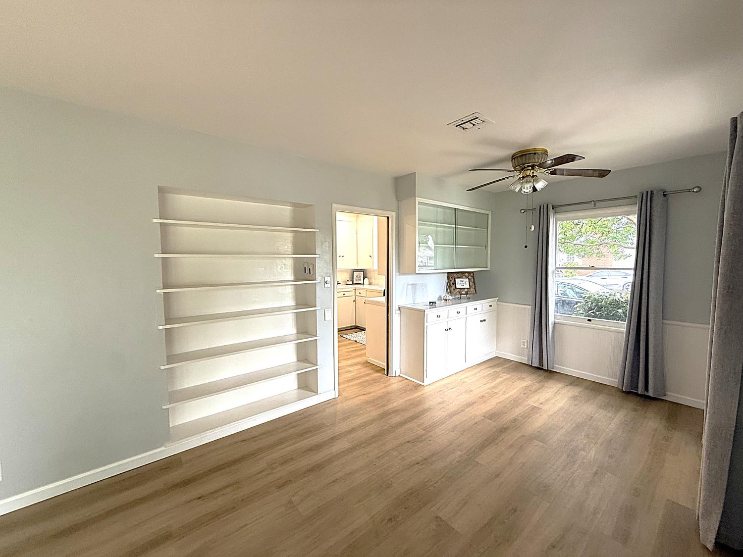 809 South Sowell Street Visalia, CA 93277 - Photo 11 of 58 a view of a kitchen with wooden floor and a window