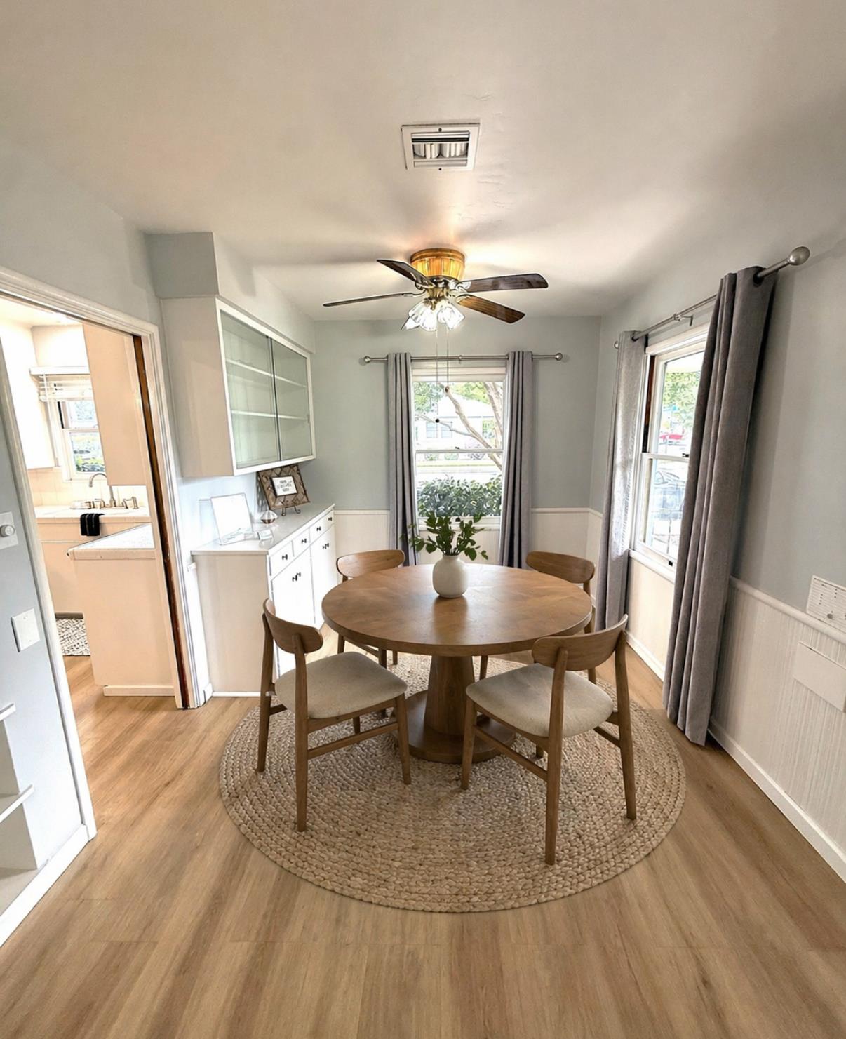809 South Sowell Street Visalia, CA 93277 - Photo 13 of 58 a view of a dining room with furniture and wooden floor