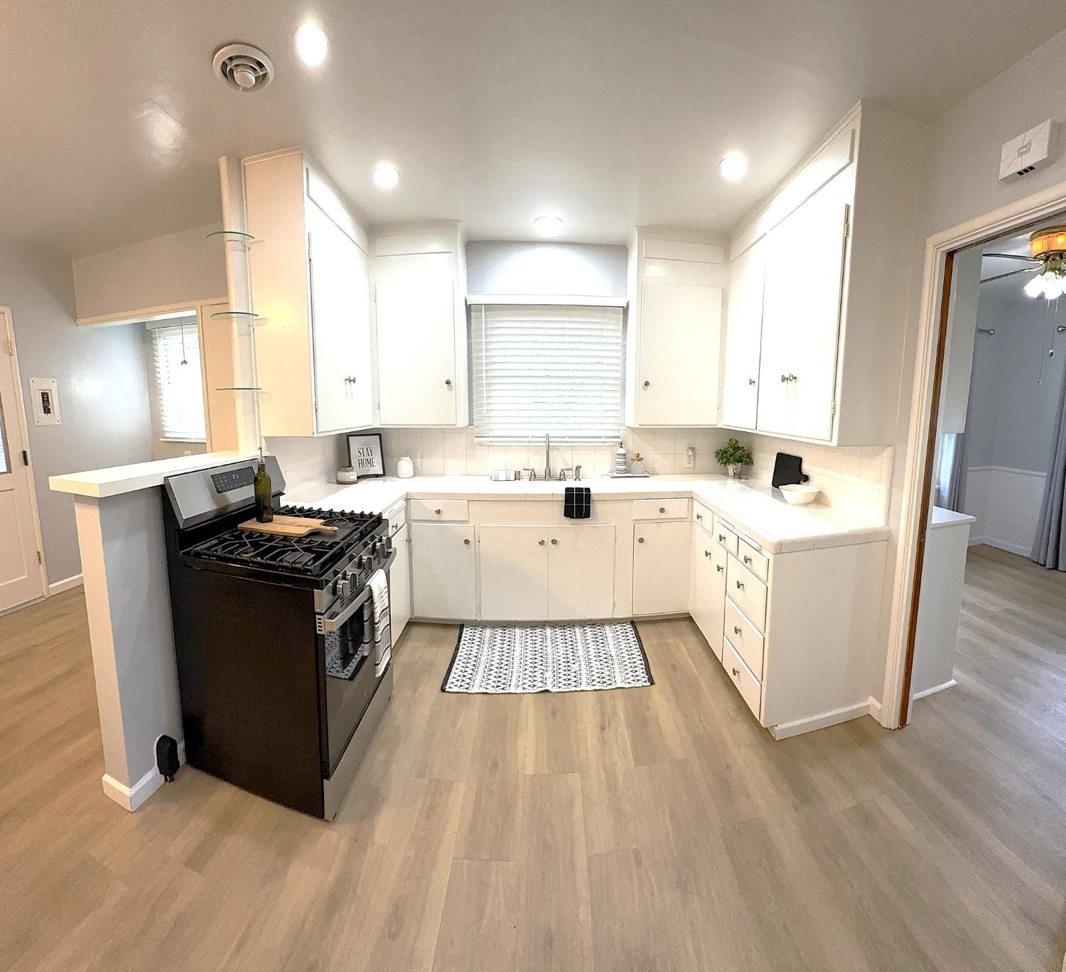 809 South Sowell Street Visalia, CA 93277 - Photo 14 of 58 a kitchen with a sink a window stainless steel appliances and cabinets