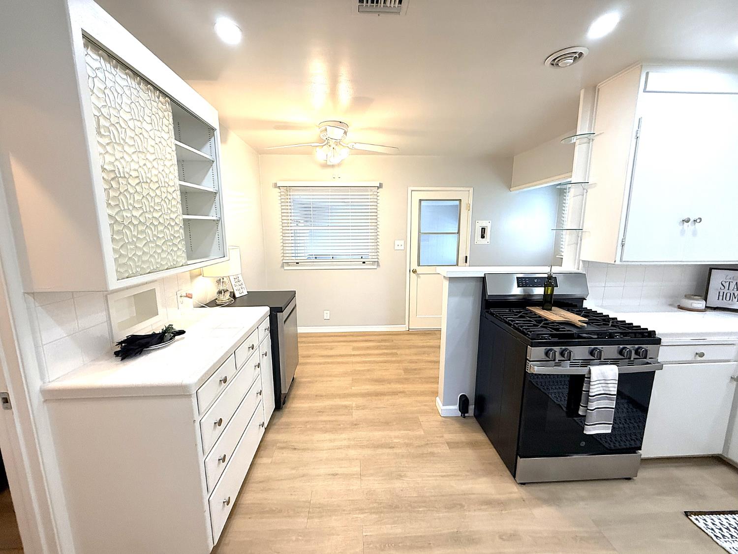 809 South Sowell Street Visalia, CA 93277 - Photo 23 of 58 a kitchen with stainless steel appliances a stove a sink and a refrigerator
