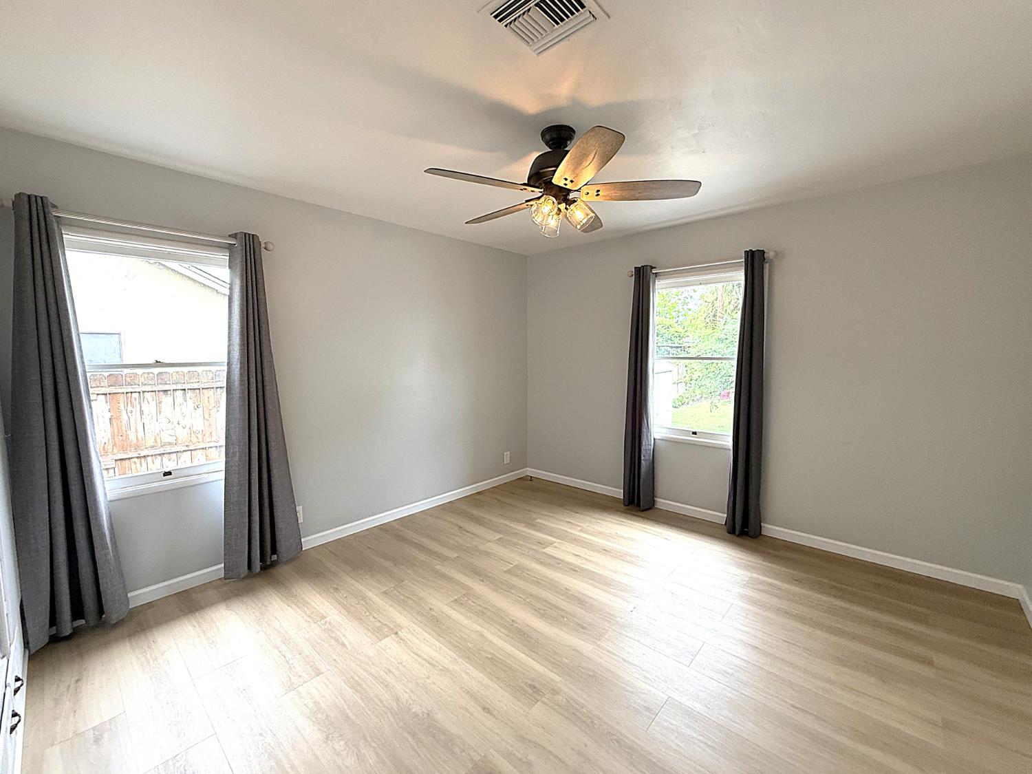 809 South Sowell Street Visalia, CA 93277 - Photo 33 of 58 an empty room with windows and fan