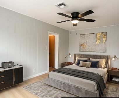 809 South Sowell Street Visalia, CA 93277 - Photo 41 of 58 a bedroom with a bed and wooden floor