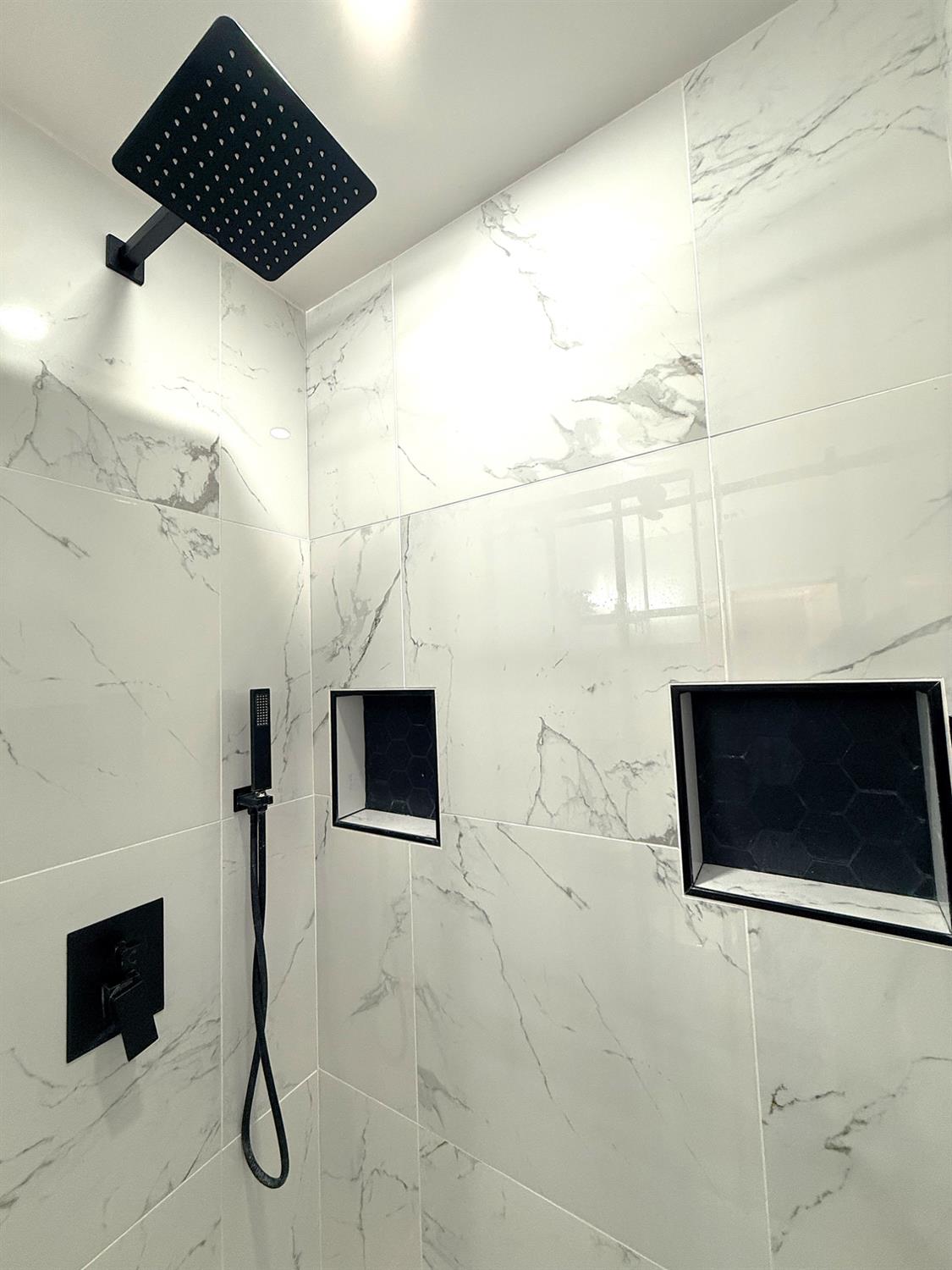 809 South Sowell Street Visalia, CA 93277 - Photo 43 of 58 a bathroom with a shower a mirror and a sink