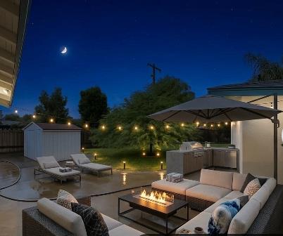 809 South Sowell Street Visalia, CA 93277 - Photo 52 of 58 a view of a patio with couches table and chairs under an umbrella with a fire pit