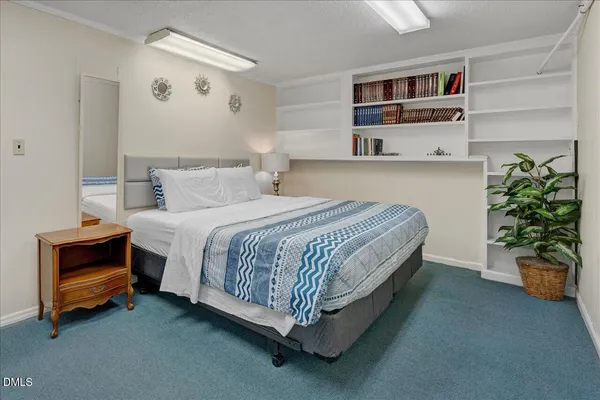 a bedroom with a bed and a potted plant