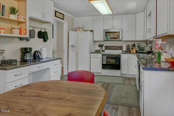 a kitchen with stainless steel appliances a stove microwave and refrigerator