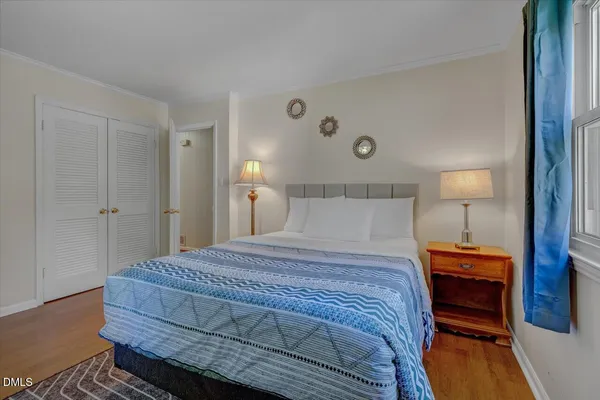 a bedroom with a bed and a lamp