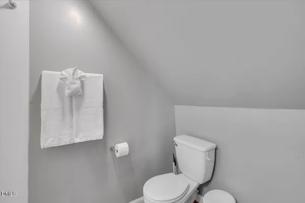 a white toilet sitting next to a bathroom sink