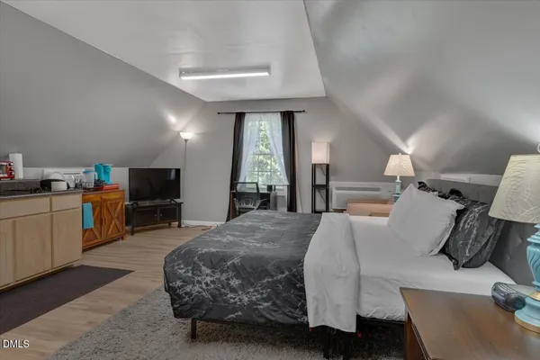 a kitchen with a refrigerator a stove and a wooden floor