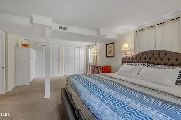 a bedroom with a large bed and a couch