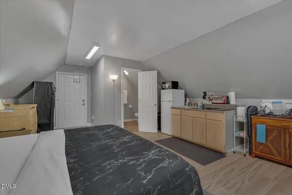 a bedroom with a bed a lamp and a large window