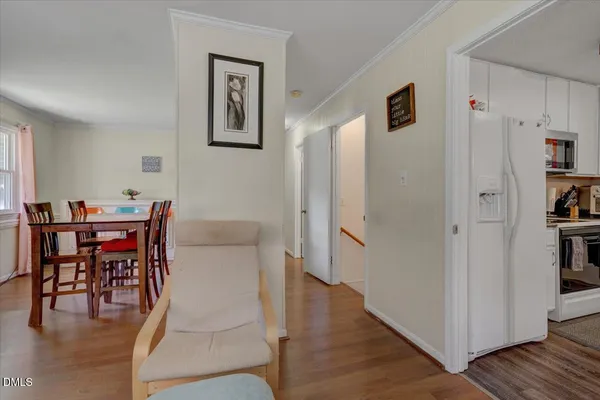 a dining room with furniture and wooden floor
