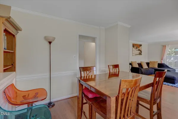 a view of a dining room with furniture and a potted plant