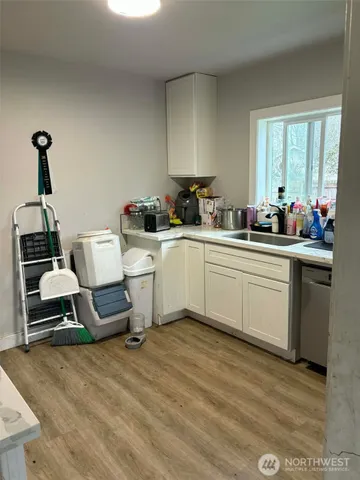 a kitchen with a sink cabinets and window