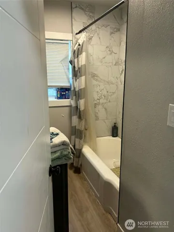 a bathroom with a bathtub and shower