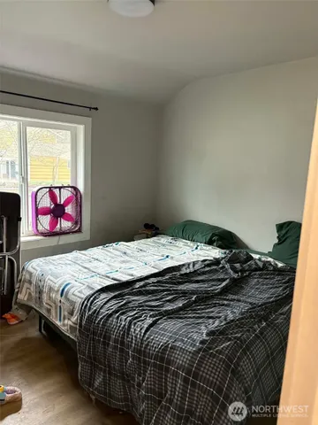 a bedroom with a bed and dresser