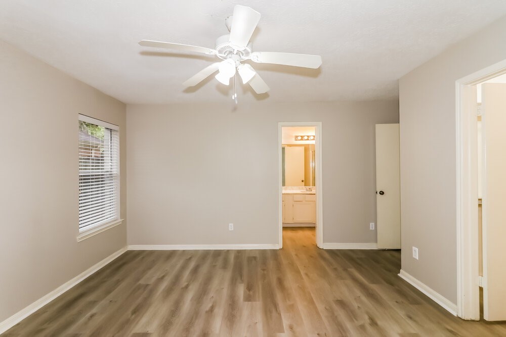 4635 Linden Place Pearland, TX 77584 - Photo 11 of 17 a view of an empty room with wooden floor and window