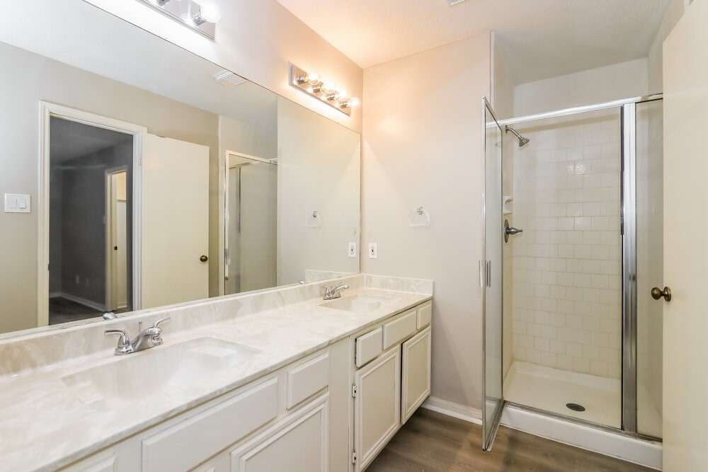 4635 Linden Place Pearland, TX 77584 - Photo 12 of 17 a bathroom with a granite countertop sink mirror and double