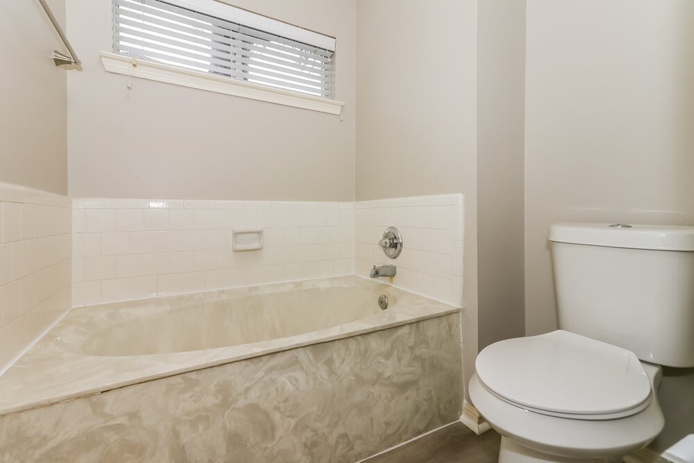 4635 Linden Place Pearland, TX 77584 - Photo 16 of 17 a white toilet sitting next to a bath tub