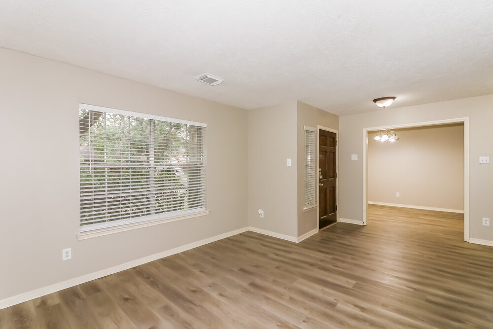 4635 Linden Place Pearland, TX 77584 - Photo 7 of 17 a view of an empty room with wooden floor and a window