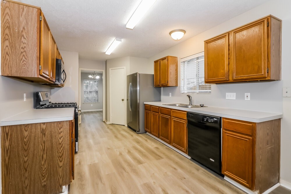 4635 Linden Place Pearland, TX 77584 - Photo 8 of 17 a kitchen with stainless steel appliances granite countertop a sink and cabinets