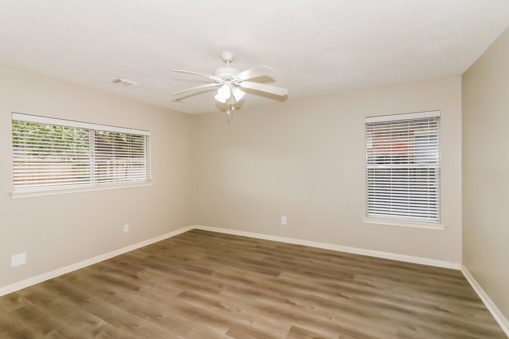 4635 Linden Place Pearland, TX 77584 - Photo 10 of 17 a view of an empty room with wooden floor and a window