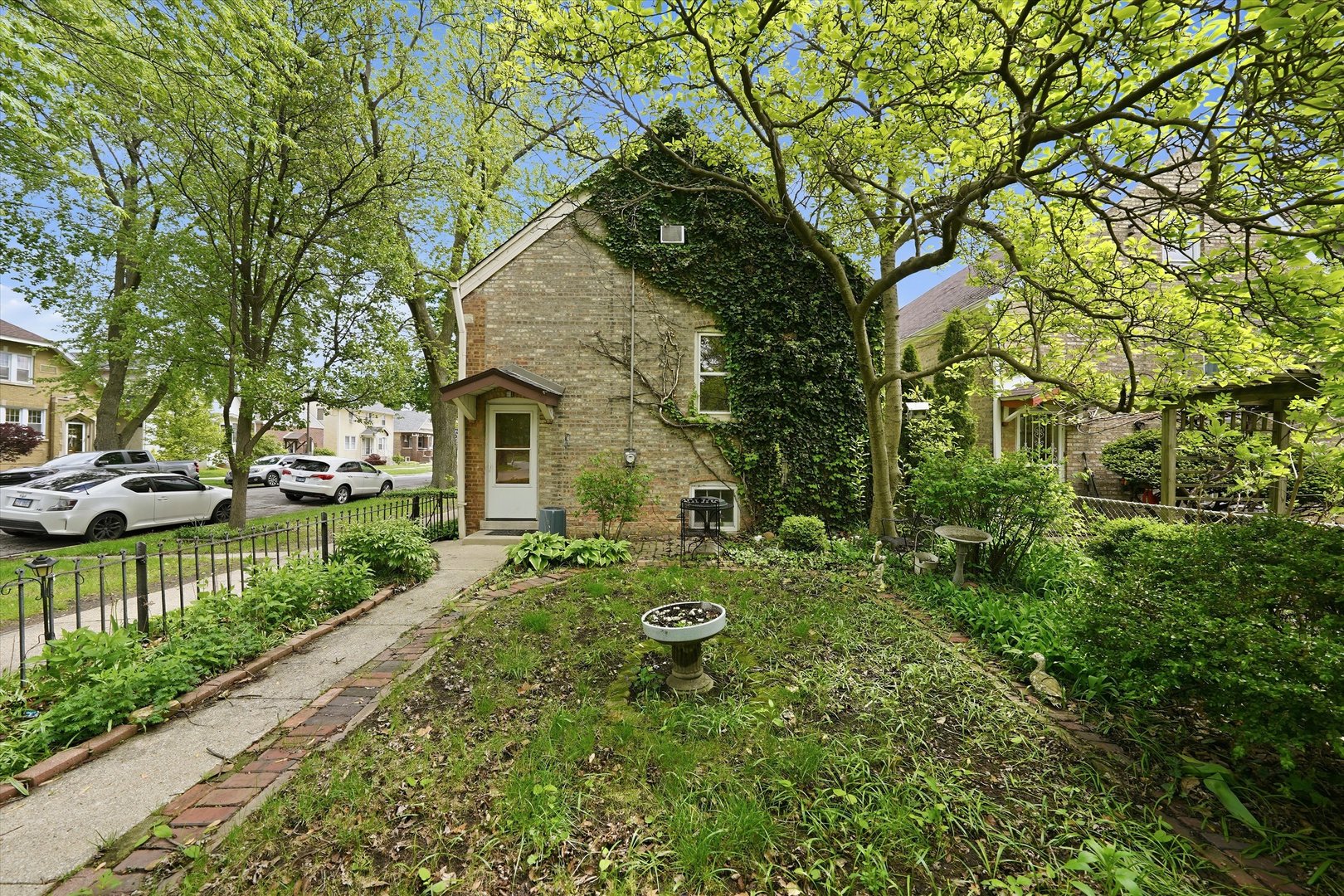 3100 Clinton Avenue Berwyn, IL 60402 - Photo 21 of 25 a front view of a house with a yard table and chairs