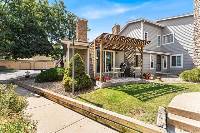 a view of a house with backyard and sitting area