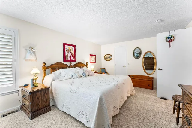 a bedroom with bed and a window