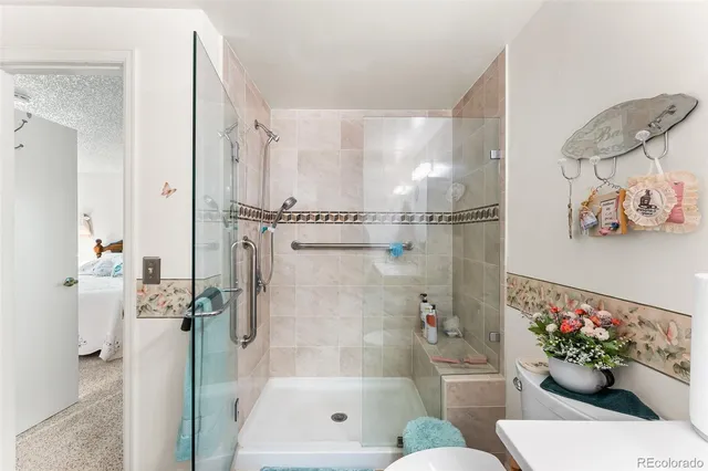 a bathroom with a shower a toilet and a shower curtain