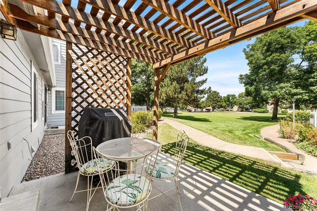 a view of a chairs and table in backyard of the house