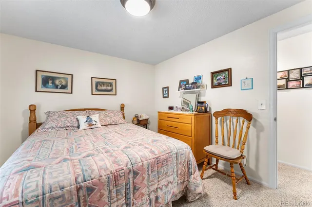 a bedroom with a bed and a chair